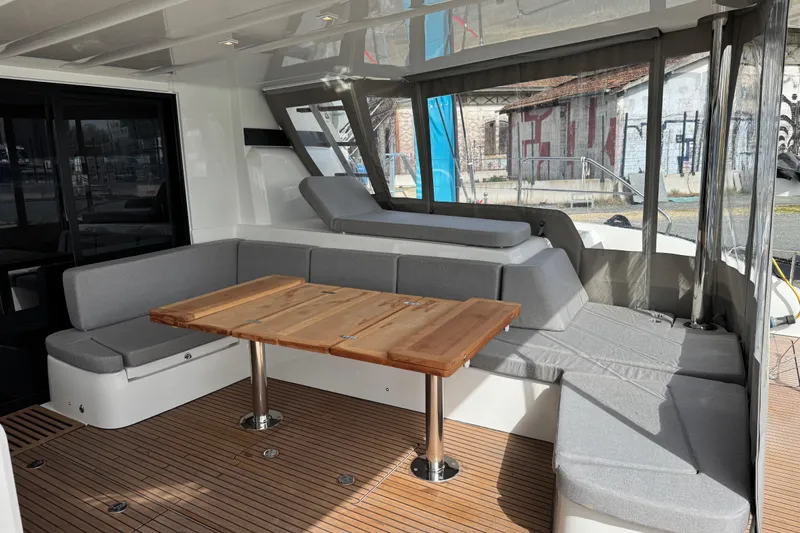  Yacht Photos Pics Luxurious Lagoon 55 yacht interior with modern seating and wooden table, 2026 model.