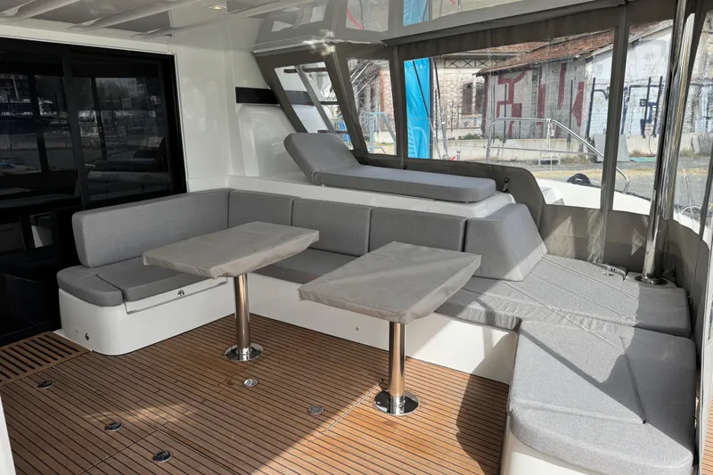  Yacht Photos Pics Luxurious interior of 2026 Lagoon 55 yacht with modern seating and wooden flooring.