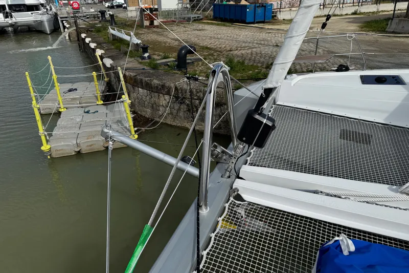  Yacht Photos Pics 2026 Lagoon 55 yacht docked at marina with floating platform.