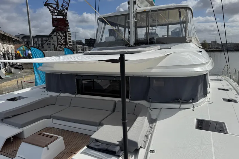  Yacht Photos Pics 2026 Lagoon 55 yacht with spacious deck and modern design in a marina setting.