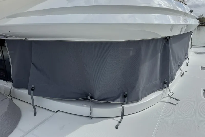  Yacht Photos Pics 2026 Lagoon 55 yacht with gray protective cover on deck.