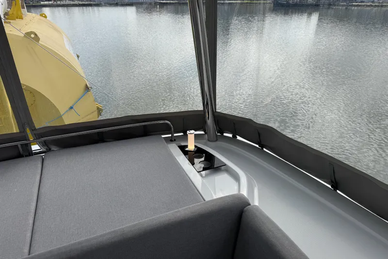  Yacht Photos Pics Luxurious Lagoon 55 yacht interior with comfortable seating, overlooking serene water.