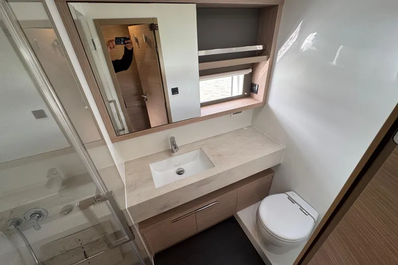  Yacht Photos Pics Modern bathroom in 2026 Lagoon 55 yacht with sleek fixtures and ample storage.