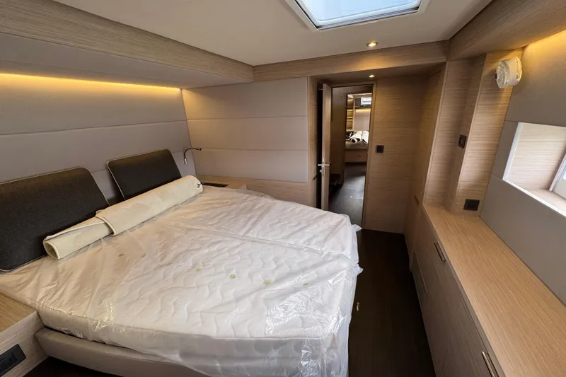  Yacht Photos Pics Luxurious interior of 2026 Lagoon 55 yacht with modern bedroom design.