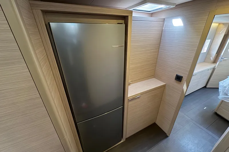  Yacht Photos Pics Modern kitchen interior of 2026 Lagoon 55 yacht with sleek refrigerator.
