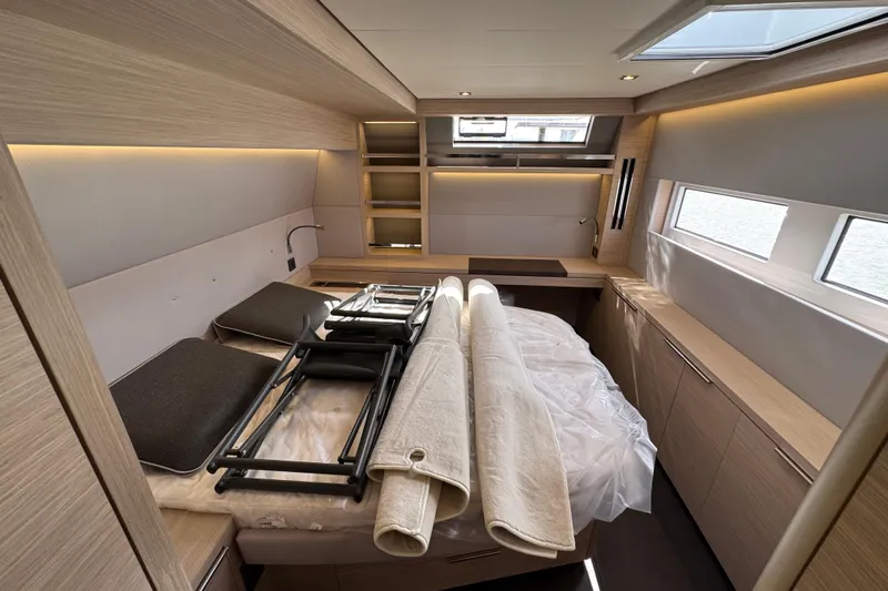  Yacht Photos Pics Luxurious interior of 2026 Lagoon 55 yacht cabin with modern furnishings and natural light.