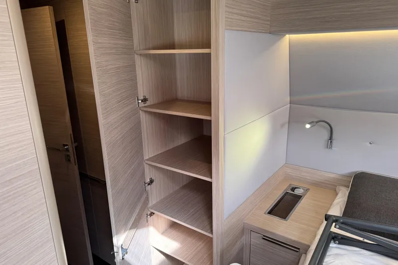  Yacht Photos Pics Interior of 2026 Lagoon 55 yacht with open shelving and modern lighting.