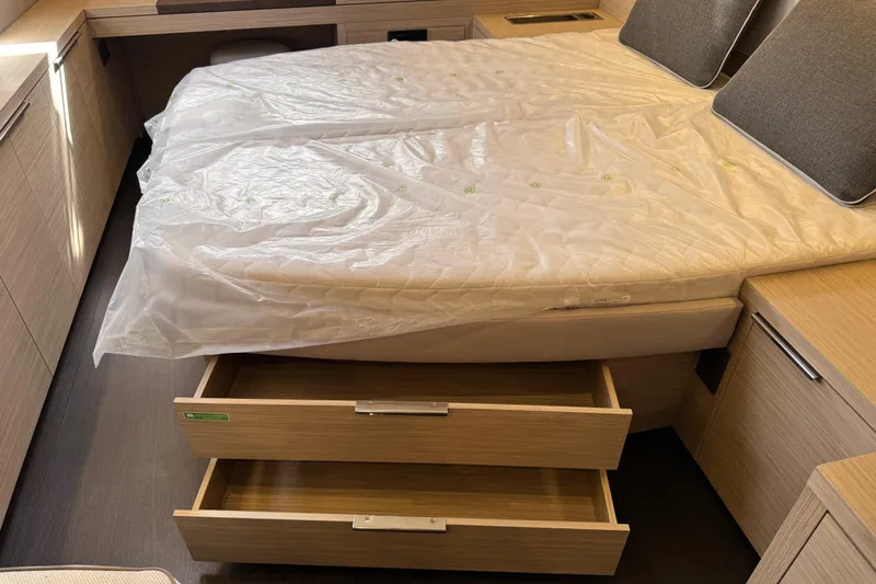  Yacht Photos Pics Interior of 2026 Lagoon 55 yacht with bed and open storage drawers.