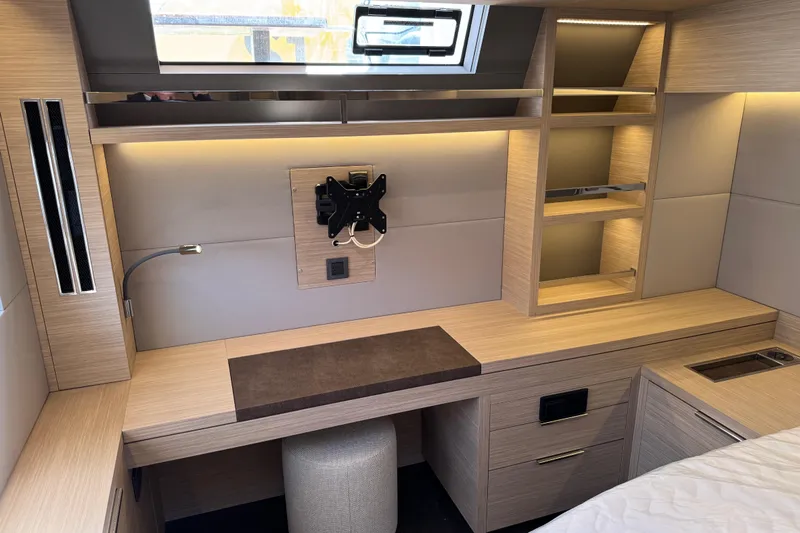  Yacht Photos Pics Modern interior of 2026 Lagoon 55 yacht with sleek wooden cabinetry and ambient lighting.