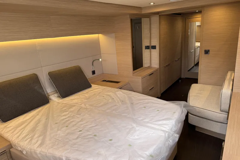  Yacht Photos Pics Luxurious bedroom interior of 2026 Lagoon 55 yacht with modern design and ambient lighting.