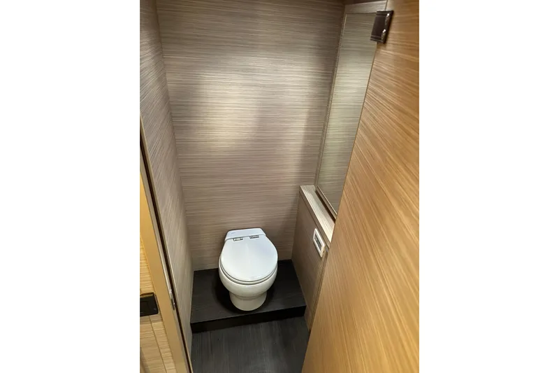  Yacht Photos Pics Modern bathroom interior on 2026 Lagoon 55 yacht, featuring sleek design and wood paneling.