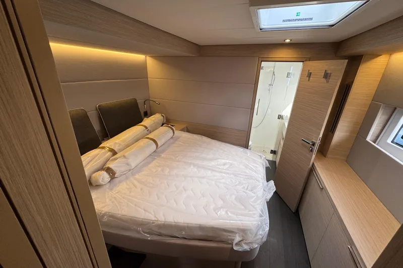  Yacht Photos Pics Luxurious cabin interior of 2026 Lagoon 55 yacht with modern design and ensuite bathroom.