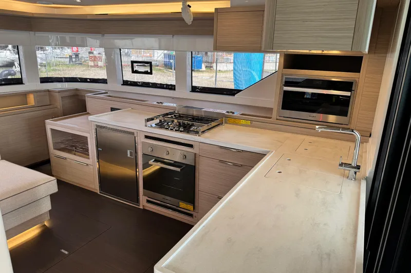  Yacht Photos Pics Modern kitchen interior of 2026 Lagoon 55 yacht with sleek appliances and ample counter space.