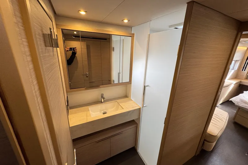  Yacht Photos Pics Modern bathroom interior in 2026 Lagoon 55 yacht, featuring sleek design and wood accents.