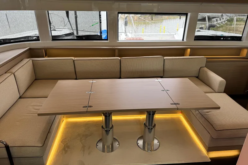  Yacht Photos Pics Luxurious interior of 2026 Lagoon 55 yacht with elegant seating and modern table design.