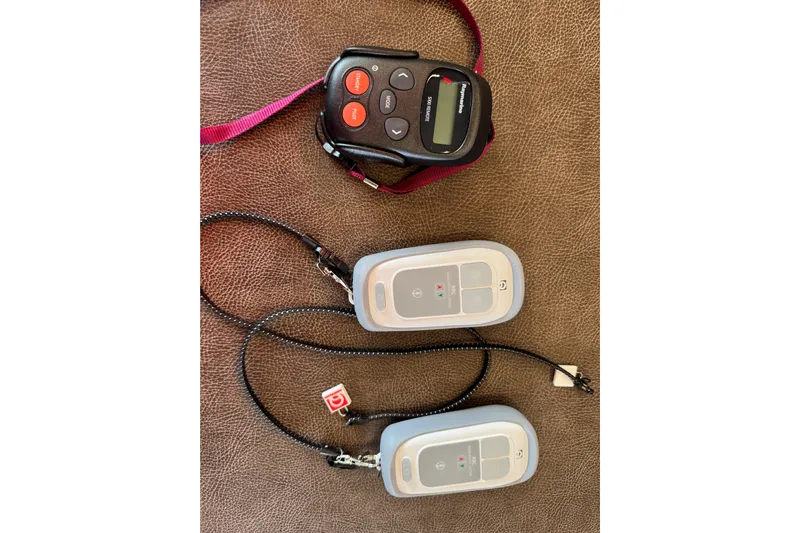  Yacht Photos Pics Remote controls for Lagoon 55 yacht, 2026 model, on a brown surface.