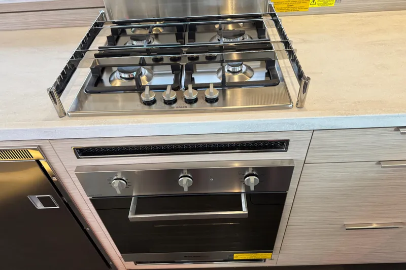  Yacht Photos Pics Modern kitchen in 2026 Lagoon 55 yacht with stainless steel stove and oven.