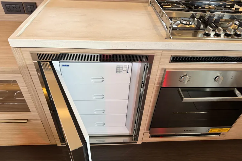  Yacht Photos Pics Modern kitchen in 2026 Lagoon 55 yacht with fridge and stove.