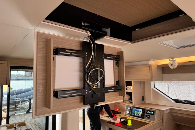  Yacht Photos Pics Interior of 2026 Lagoon 55 yacht with retractable TV mount and modern control panel.