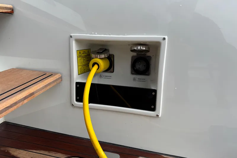  Yacht Photos Pics 2026 Lagoon 55 yacht shore power connection with yellow cable and wooden steps.