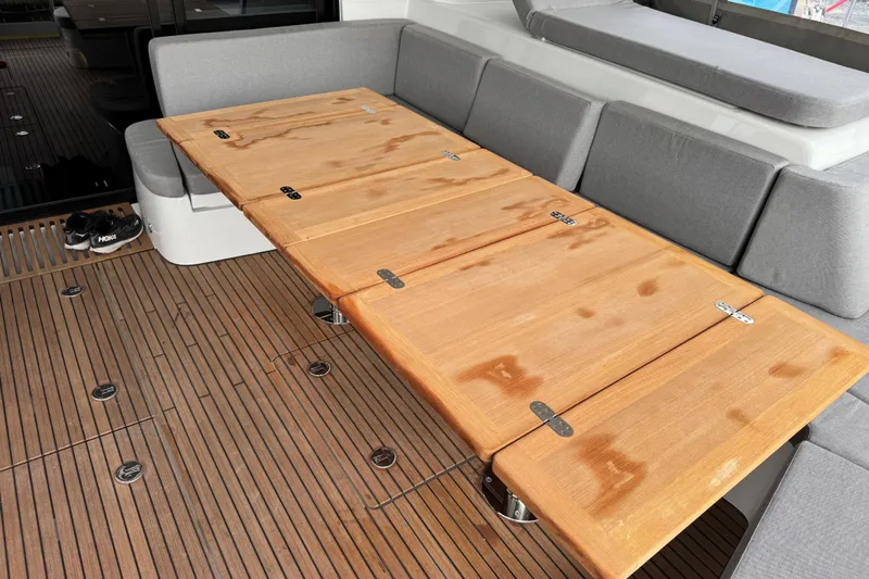  Yacht Photos Pics Luxurious Lagoon 55 yacht interior with wooden table and gray seating, 2026 model.