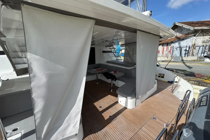  Yacht Photos Pics 2026 Lagoon 55 yacht with spacious deck, seating area, and modern design features.