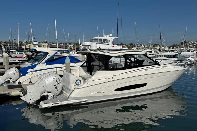 36 Xo Yacht Photos Pics 2026 Regal 36 XO yacht docked at marina, featuring sleek design and powerful engines.