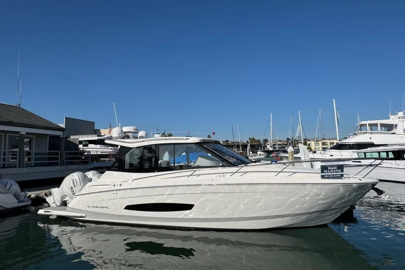 36 Xo Yacht Photos Pics 2026 Regal 36 XO luxury yacht docked at marina under clear blue sky.