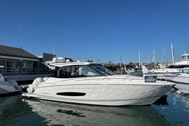 36 Xo Yacht Photos Pics 2026 Regal 36 XO yacht docked at marina under clear blue sky.