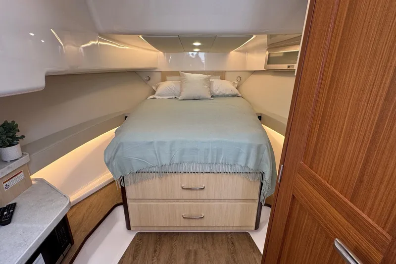 36 Xo Yacht Photos Pics Luxurious cabin interior of 2026 Regal 36 XO yacht with cozy bed and wooden accents.