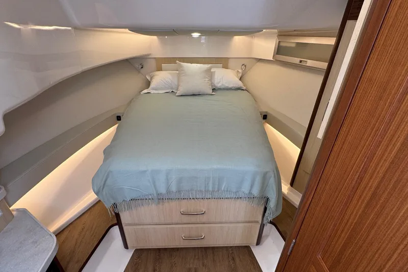 36 Xo Yacht Photos Pics 2026 Regal 36 XO yacht interior cabin with bed and wooden accents.