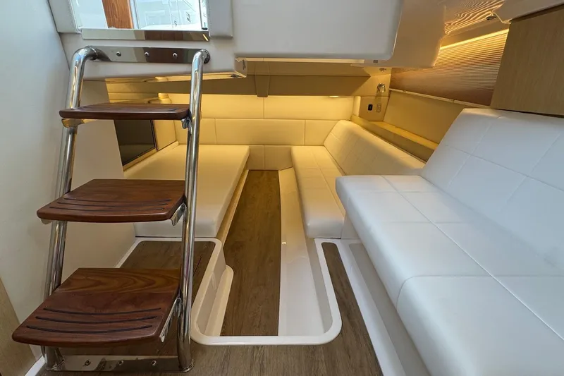 36 Xo Yacht Photos Pics Luxurious interior of 2026 Regal 36 XO yacht with white seating and wooden steps.