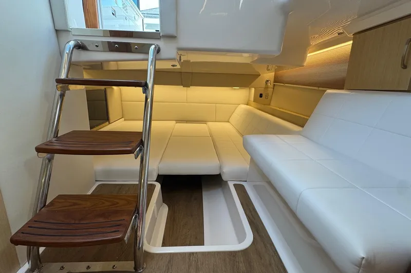 36 Xo Yacht Photos Pics Luxurious interior of 2026 Regal 36 XO yacht with white seating and wooden steps.