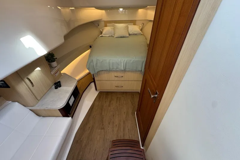 36 Xo Yacht Photos Pics Interior of 2026 Regal 36 XO yacht cabin with bed, seating, and wood flooring.