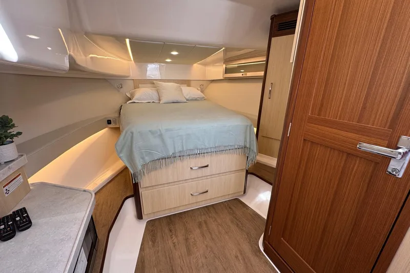 36 Xo Yacht Photos Pics Luxurious cabin interior of 2026 Regal 36 XO yacht with cozy bed and wooden accents.