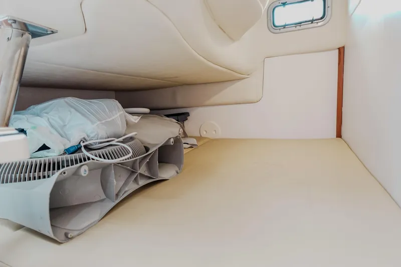  Yacht Photos Pics 2007 Boston Whaler 305 Conquest cabin interior with fan and bedding.