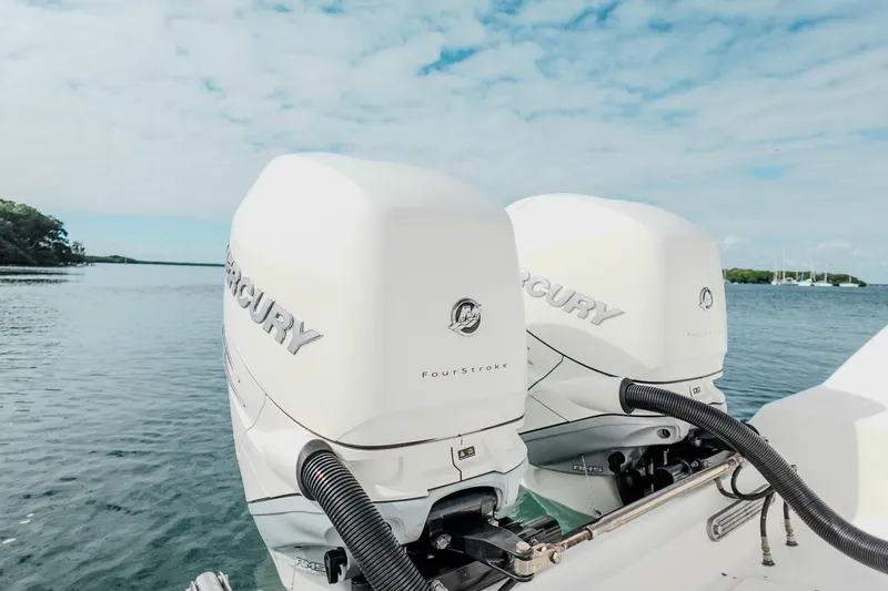  Yacht Photos Pics Twin Mercury FourStroke engines on a 2007 Boston Whaler 305 Conquest boat, scenic water backdrop.