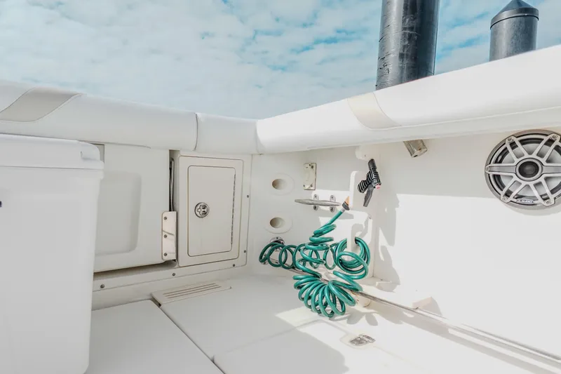  Yacht Photos Pics 2007 Boston Whaler 305 Conquest boat interior with storage, speaker, and coiled hose.