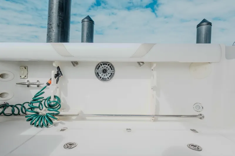  Yacht Photos Pics 2007 Boston Whaler 305 Conquest boat deck with hose and speaker, under blue sky.