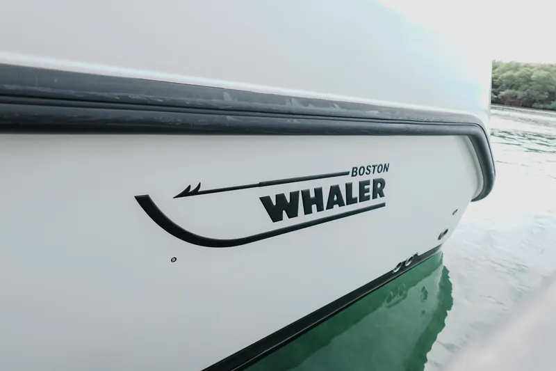  Yacht Photos Pics 2007 Boston Whaler 305 Conquest boat side view on water.