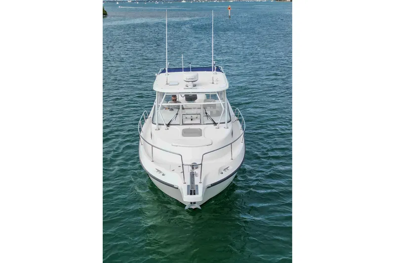  Yacht Photos Pics 2007 Boston Whaler 305 Conquest boat on calm water, front view.