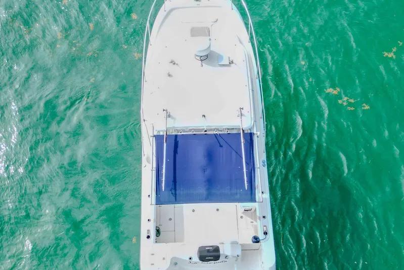  Yacht Photos Pics Aerial view of 2007 Boston Whaler 305 Conquest on turquoise water.