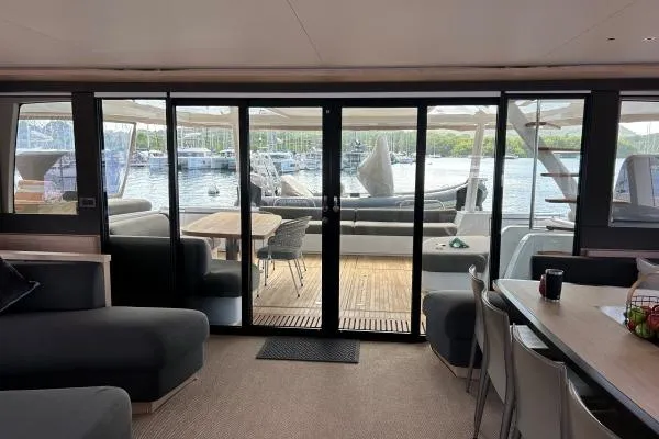 Maty Yacht Photos Pics Luxurious interior of 2023 Lagoon Seventy 7 yacht with scenic marina view.