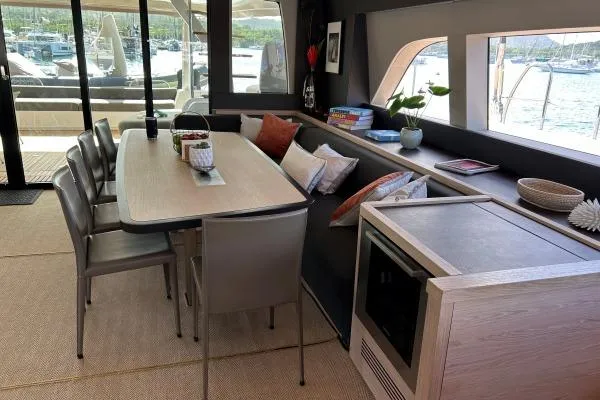 Maty Yacht Photos Pics Luxurious interior of 2023 Lagoon Seventy 7 yacht with elegant dining area and scenic views.