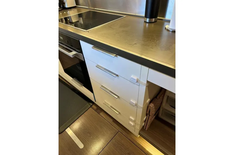 Maty Yacht Photos Pics Modern kitchen area in 2023 Lagoon Seventy 7 yacht with sleek cabinetry and appliances.