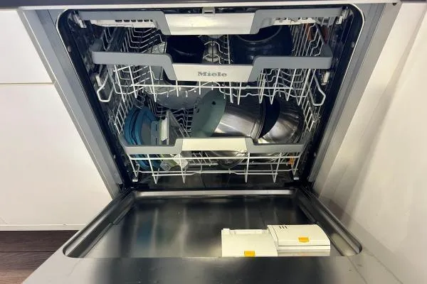 Maty Yacht Photos Pics Open Miele dishwasher with clean dishes inside, showcasing modern kitchen appliance.