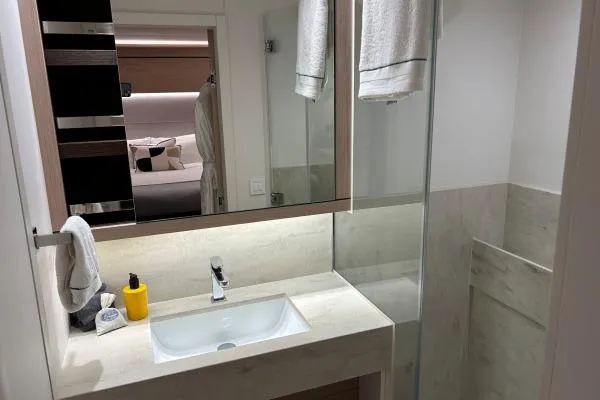 Maty Yacht Photos Pics Luxurious bathroom in 2023 Lagoon Seventy 7 yacht with modern fixtures and elegant design.