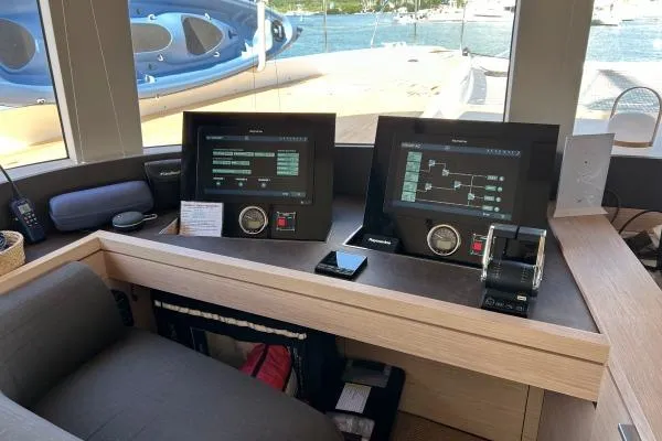 Maty Yacht Photos Pics 2023 Lagoon Seventy 7 yacht cockpit with advanced navigation systems and scenic ocean view.