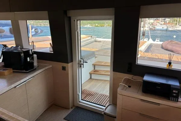 Maty Yacht Photos Pics Interior view of 2023 Lagoon Seventy 7 yacht with modern kitchen and ocean view.