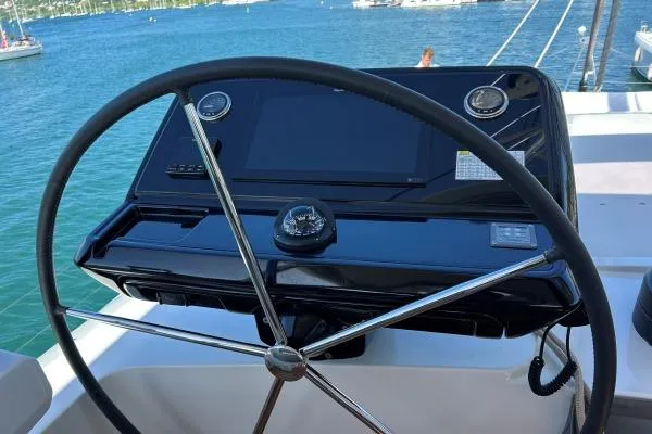 Maty Yacht Photos Pics Steering wheel and dashboard of 2023 Lagoon Seventy 7 yacht on water.